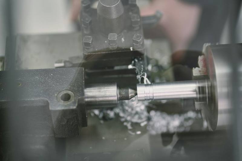 CNC lathe turning a steel component