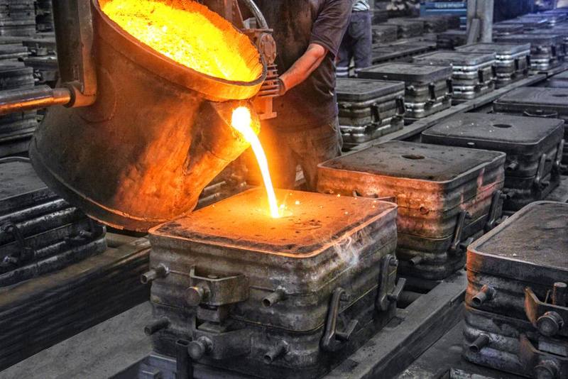 Molten metal poured into a mould in a foundry