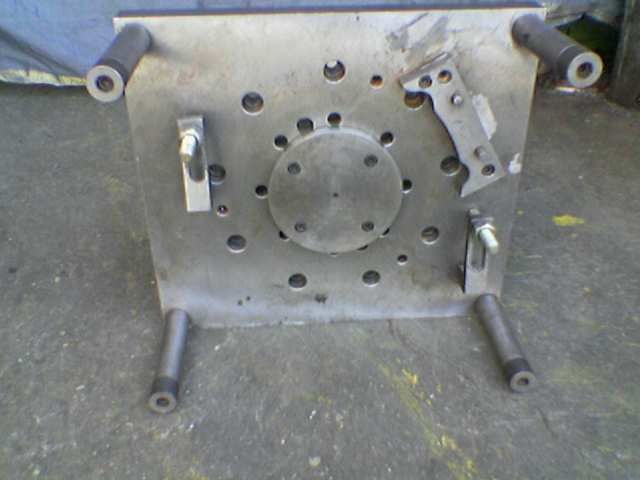 Machined plate with drilled and tapped holes
