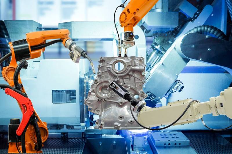 Robotic arms on an automated assembly line