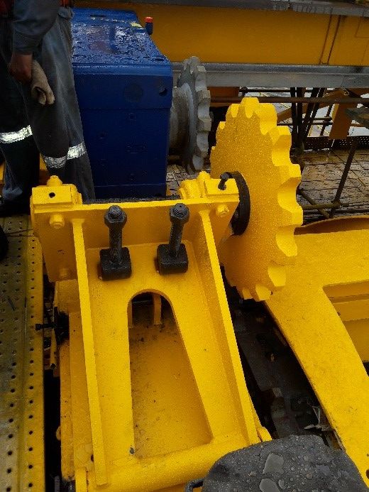 Bucket wheel tensioner and sprocket assembly